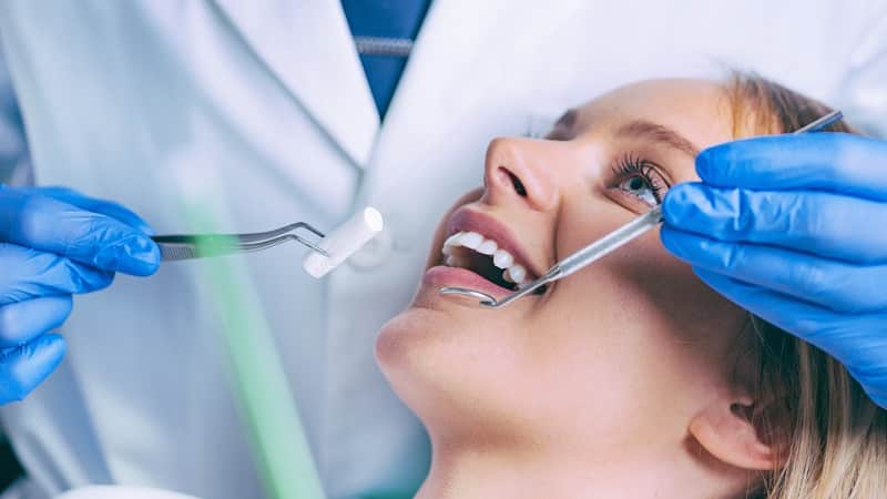 dentist working with young female patient