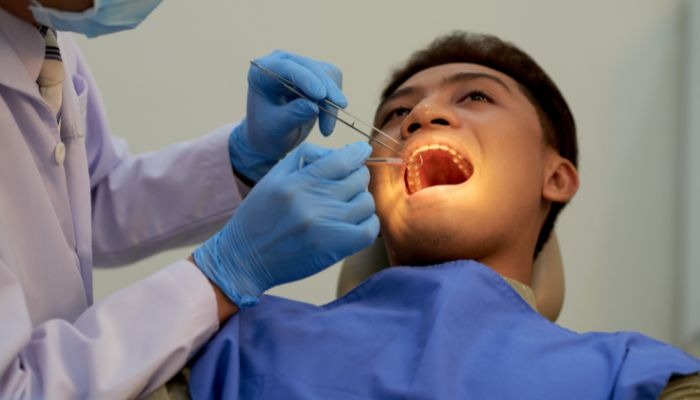Dentist performing oral examination