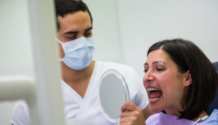 Patient checking teeth after whitening treatment.